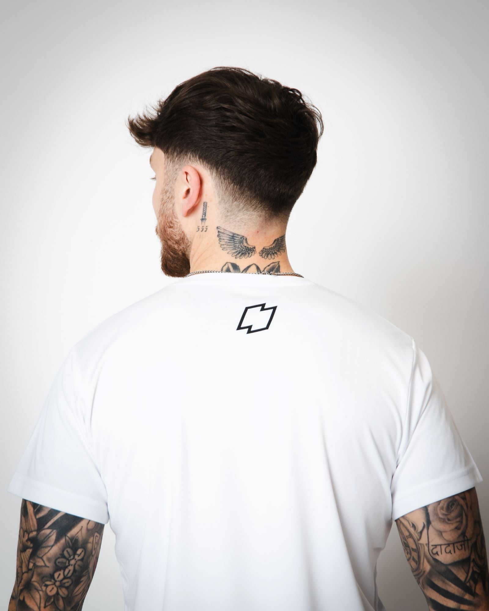 View of the back of the white OFFSET Sport T Shirt with the OFFSET logo